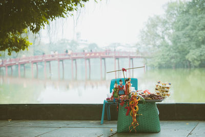 Close-up of food on table by river against sky
