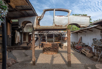 Jacked up rusty wrecked car in a backyard in livingstone, zambia