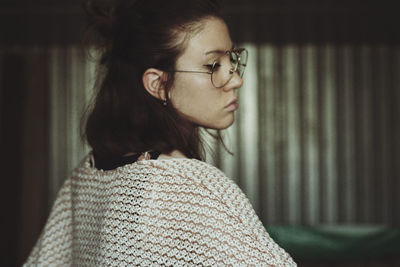 Rear view of woman looking away at home