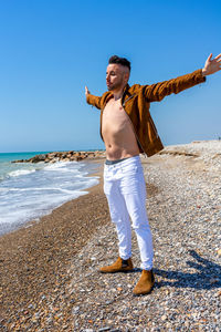 Full length of man standing on beach