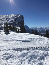 Snowcapped landscape against clear blue sky