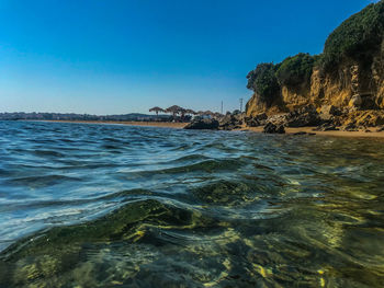 Scenic view of sea against clear blue sky