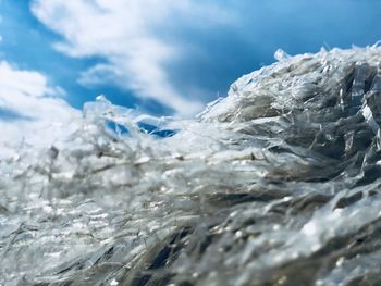 Close-up of frozen sea against sky