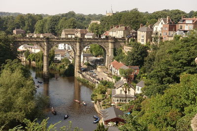 High angle view of bridge over river amidst buildings in city