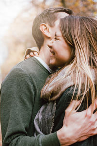 Close-up of couple embracing in park