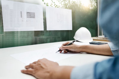 Midsection of man working on table
