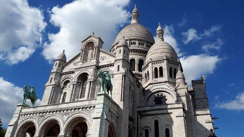 Low angle view of building against cloudy sky