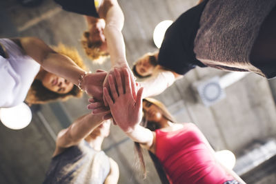 Group of young people huddling in gym