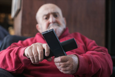 Midsection of man using mobile phone