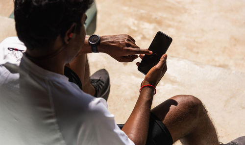 Side view of man using mobile phone