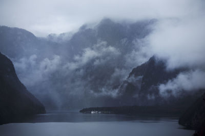 Scenic view of sea and mountains against sky