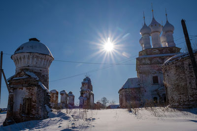 Low angle view of buildings against sky during winter