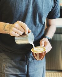 Midsection of man preparing coffee