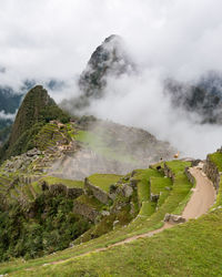 Fog covering the ruins of machu picchu in peru