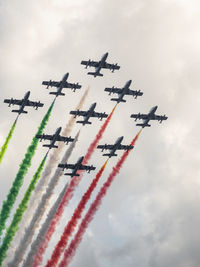 Low angle view of airplane flying against sky