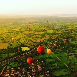 High angle view of balloons on field against sky