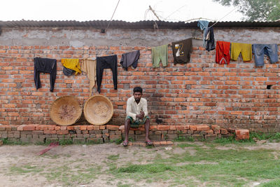 A labor taking rest in the middle of the work at the brick field.