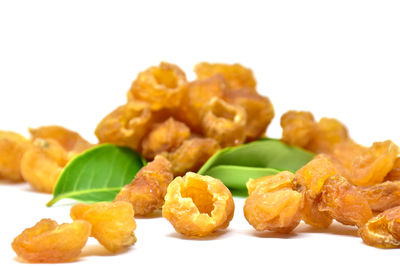 Close-up of served food in plate against white background