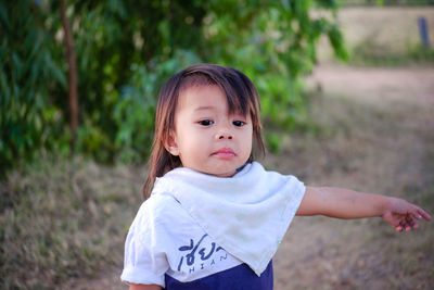 Portrait of cute girl standing outdoors