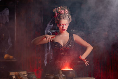 Young woman preparing food at night