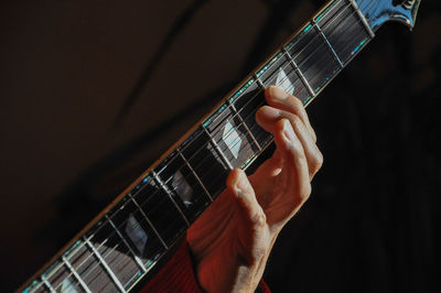 Cropped image of man playing guitar