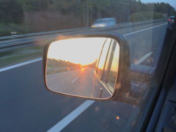 Reflection of car on side-view mirror