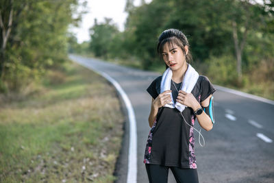 Young woman standing on road