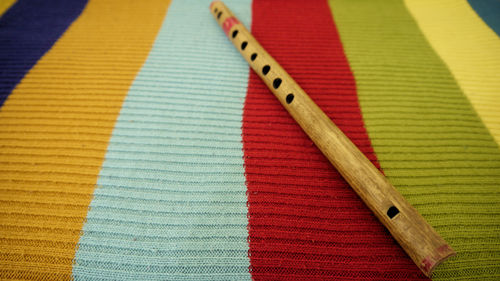 Close-up of flute on colorful fabric