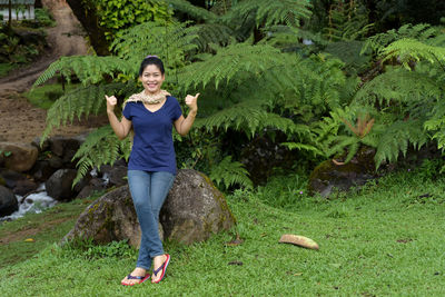 Full length portrait of woman in forest