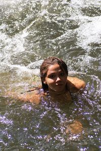 Portrait of young woman swimming in sea