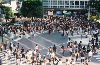 Crowd walking on city street