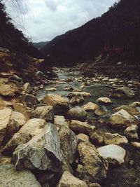 Scenic view of mountains against cloudy sky