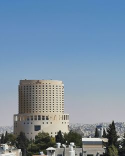 Buildings against clear blue sky