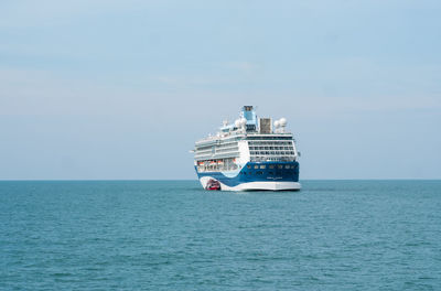 Boat sailing on sea against sky