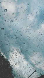 Low angle view of raindrops on window