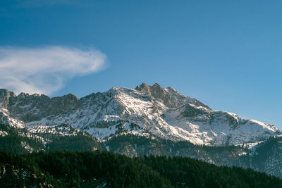 Scenic view of mountains against blue sky