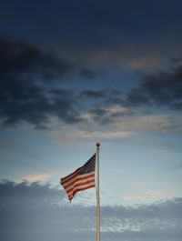 View of american flag against cloudy sky