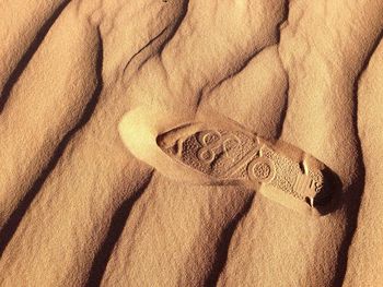 Close-up of shoe print on sand