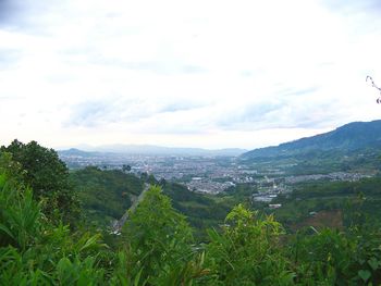 Scenic view of mountains against cloudy sky