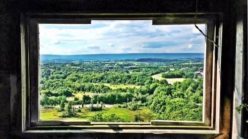 Scenic view of sea against sky seen through window