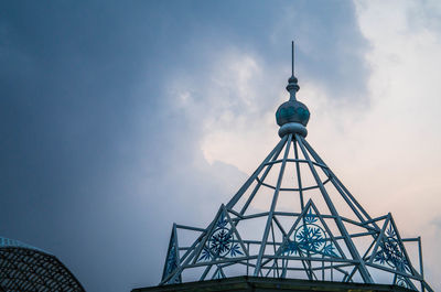 Low angle view of tower against cloudy sky