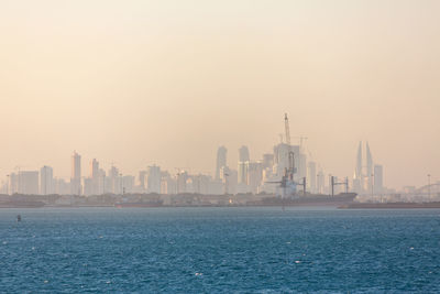 View of buildings in city against clear sky