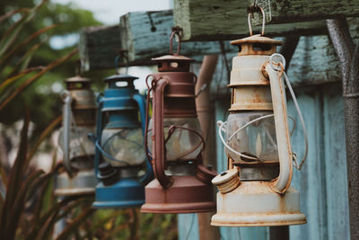 Close-up of electric lamp hanging on wood