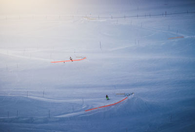 High angle view of people skiing on snow covered mountain