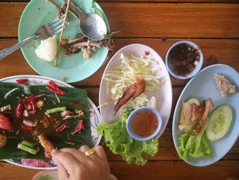 High angle view of person holding food on table