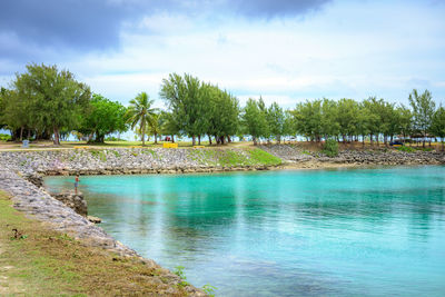 Scenic view of swimming pool by sea against sky