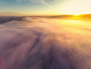 Aerial view of sea against sky during sunset