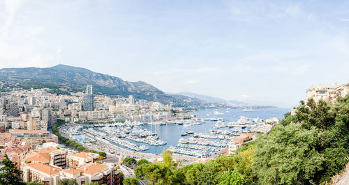 High angle view of townscape by sea against sky