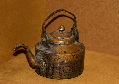 Close-up of old rusty tea kettle on table