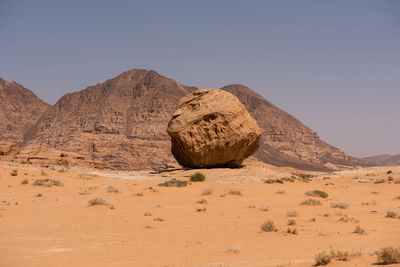 Sand dunes and sandstone cliffs in wadi rum desert , jordan